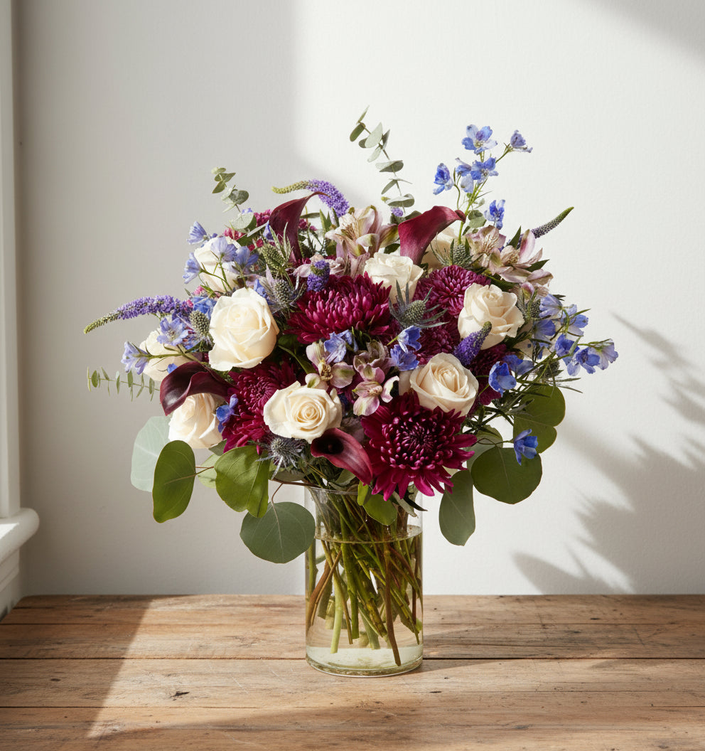 Bouquet of flowers in a clear vase on a white background